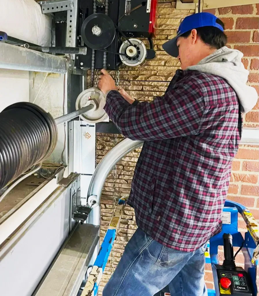 Technician Performing Garage Door Repair on Overhead Spring Mechanism