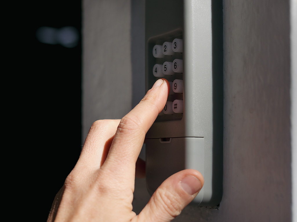 Person Entering Code on Garage Door Keypad for Garage Door Service